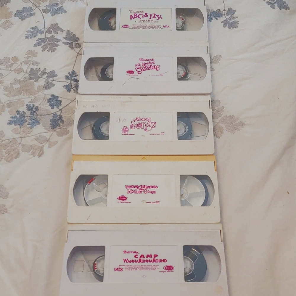 Set of five Barney vintage VHS tapes for children.